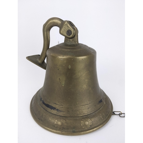 174 - A brass ships style bell with a bracket and flower head ornament
Location:LWB