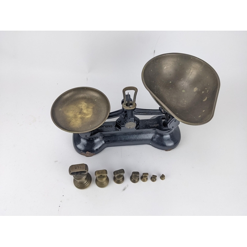 69 - Libra Scale Co black painted cast iron scales with brass pans, and a graduated set of seven bell sha... 