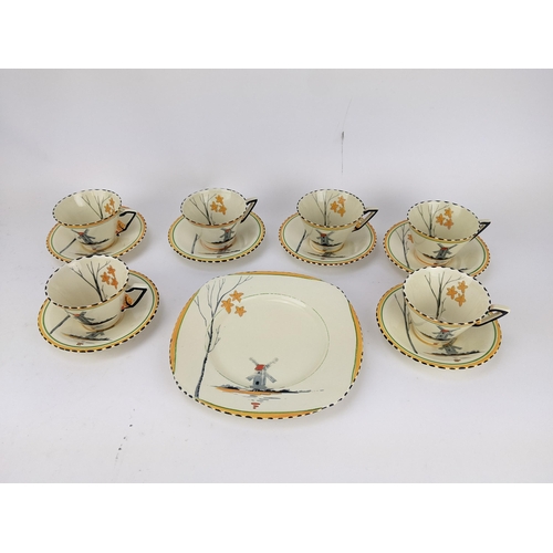 73 - A Zenith Art Deco china tea set decorated with a windmill by a lake and tree comprising six cups, si... 