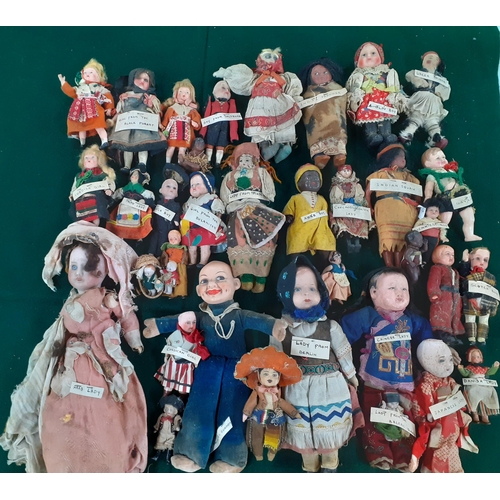 115 - A collection of worldwide and vintage dolls to include bisque and paper mâché examples, a Norah Well... 