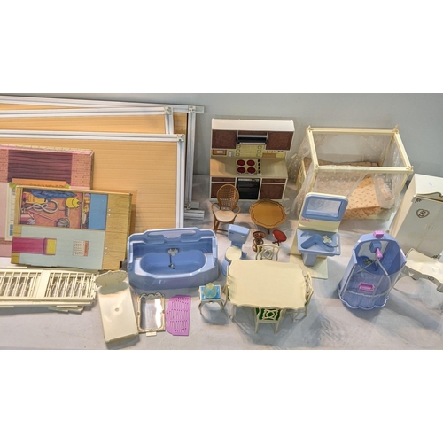 119 - A 1970's and later Sindy house and accessories to include a bath, wardrobe, double four poster bed, ... 