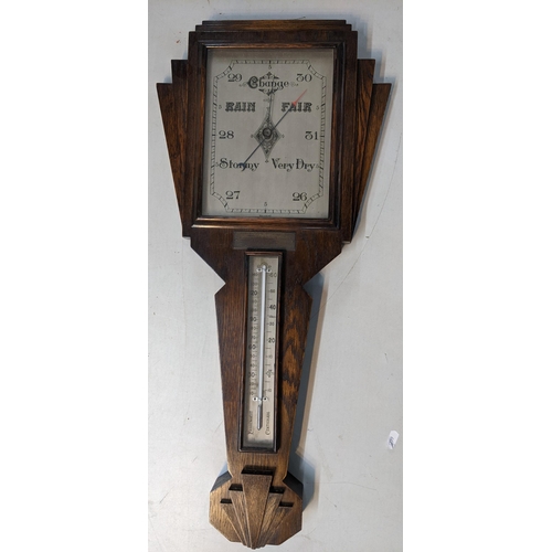 22 - An Art Deco oak wall hanging barometer having a silvered dial and presentation plaque, 71cm h x 33cm... 