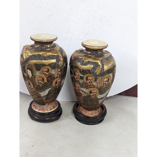 49 - A pair of Meiji period Japanese Satsuma vases, decorated with painted portraits of gentleman, makers... 