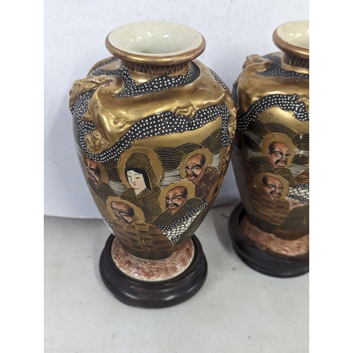 49 - A pair of Meiji period Japanese Satsuma vases, decorated with painted portraits of gentleman, makers... 