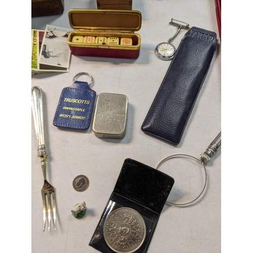 65 - A mixed lot to include silver plate, a Wedgewood biscuit barrel, nurses watch, cigarette and cards
L... 