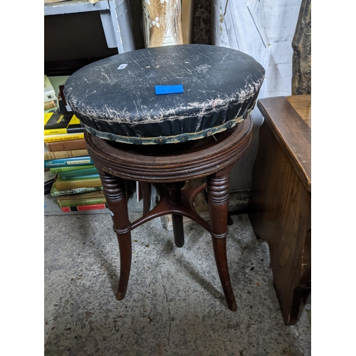 470 - A Victorian mahogany swivel top music stool with black upholstered circular seat, and a small oak li... 