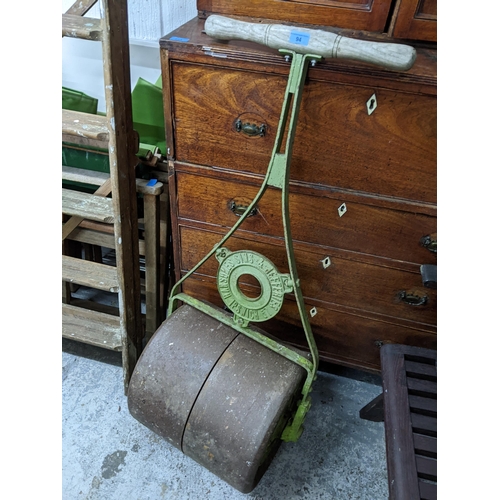 94 - An early 20th century green painted cast iron Ransomes Sims and Jefferies garden roller with wooden ... 