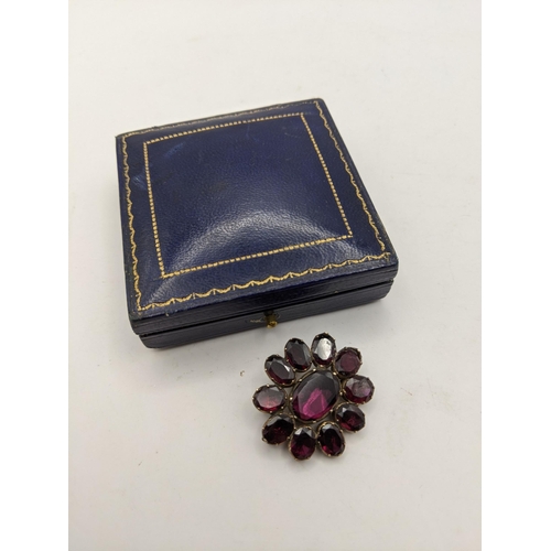 136 - AA 19th century pinchbeck yellow metal brooch with eleven purple stones, total weight 6.7g, Location... 