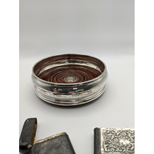 48 - A mixed lot of silver to include a silver wine coaster, together with silver front leather bound dai... 