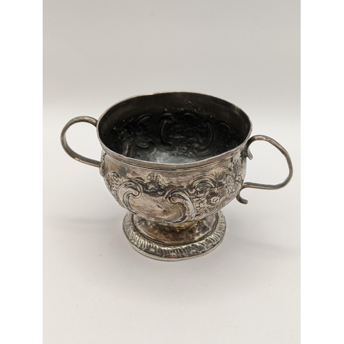 53 - A 19th century continental white metal twin handled bowl, 74.4g, together with a silver handled shoe... 