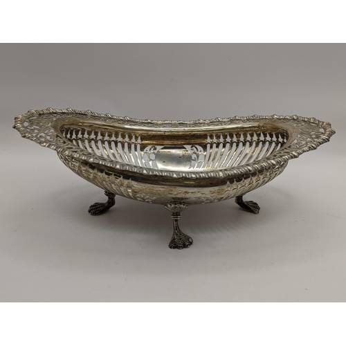 109 - An Edwardian silver pierced dish having a gadrooned rim and raised on four feet, hallmarked Birmingh... 