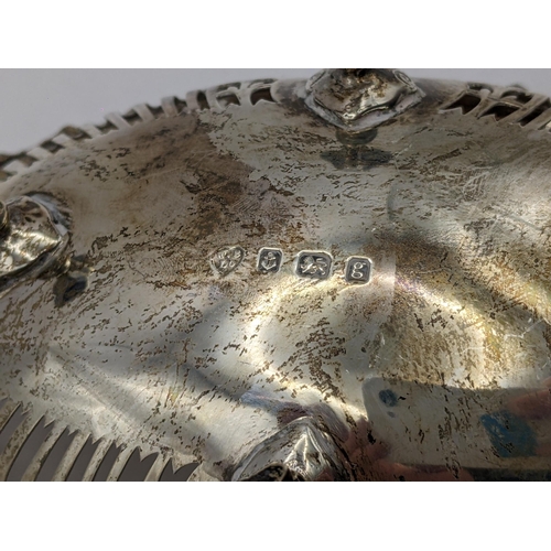 109 - An Edwardian silver pierced dish having a gadrooned rim and raised on four feet, hallmarked Birmingh... 