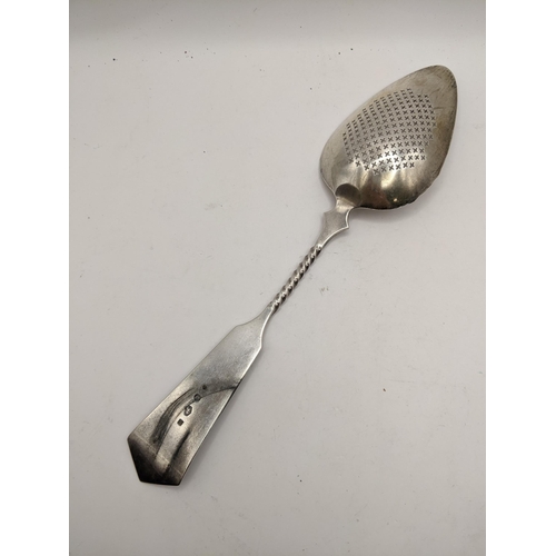 128 - A continental white metal straining spoon having a beaded band and twisted column, 624g, Location:CA... 