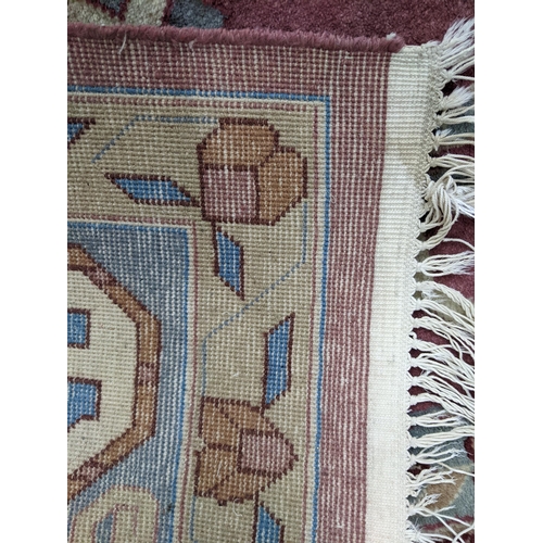 156 - A hand woven Turkish red ground rug having a central motif and a beige centre, 276 x 180w, Location:... 