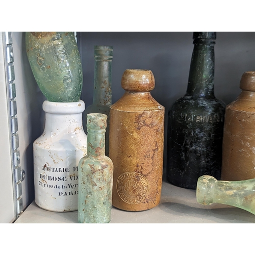 161 - A group of mixed 18th/19th century glass and stoneware bottles and flasks A/F, to include advertisin... 