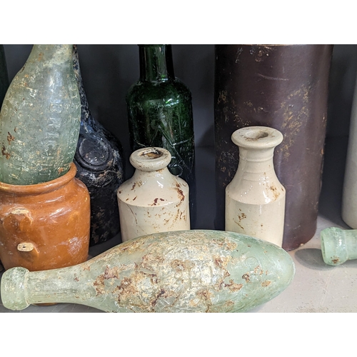 161 - A group of mixed 18th/19th century glass and stoneware bottles and flasks A/F, to include advertisin... 