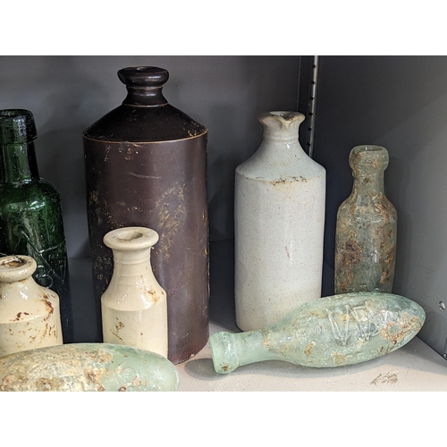 161 - A group of mixed 18th/19th century glass and stoneware bottles and flasks A/F, to include advertisin... 