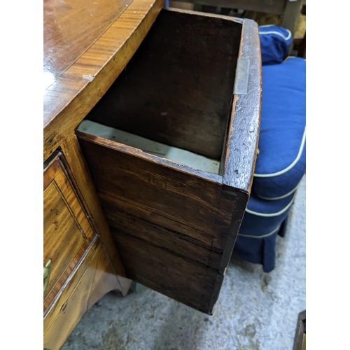 202 - A Georgian mahogany bow fronted kneehole sideboard with brass top rail, inlaid stringing, later bras... 