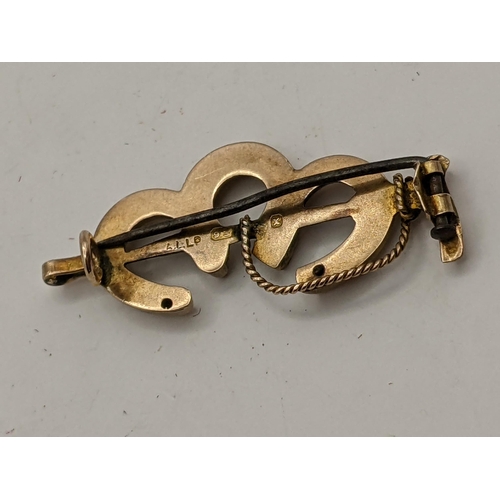 25 - A 9ct gold brooch fashioned as three horseshoes and a riding crop, 1.7g, Location:CAB2