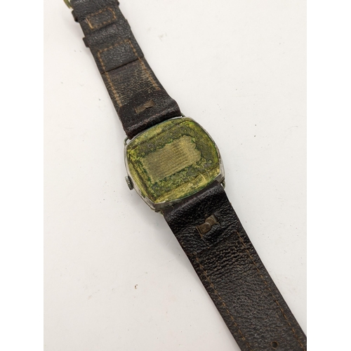 26 - A Helma German military wristwatch in a cushion moulded case and on a leather strap, Location:CAB3