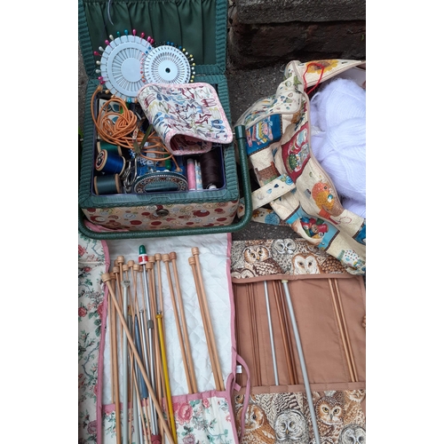 347 - A quantity of knitting needles to include wooden examples, mixed wool, a sewing basket and related i... 