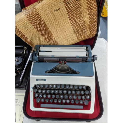 169 - A 20th century underwood typewriter including a manual, along with an Erika typewriter and The New R... 