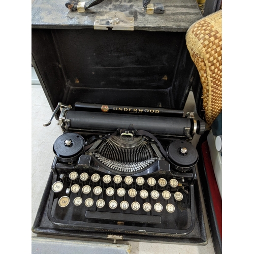 169 - A 20th century underwood typewriter including a manual, along with an Erika typewriter and The New R... 