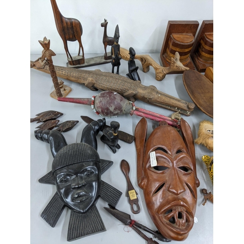 172 - Mixed treen items to include carved wooden masks, carved wooden fish, together with carved animals a... 