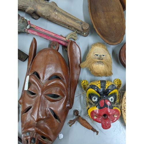 172 - Mixed treen items to include carved wooden masks, carved wooden fish, together with carved animals a... 