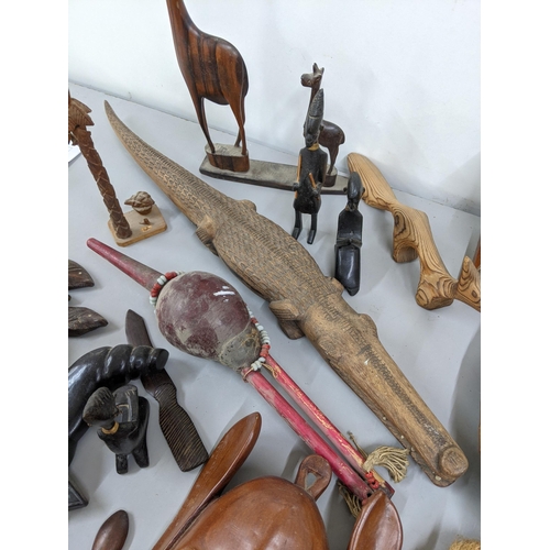 172 - Mixed treen items to include carved wooden masks, carved wooden fish, together with carved animals a... 