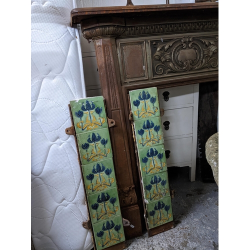 216 - A late Victorian cast iron fire surround having cast scrolled leaf and floral decoration, with two p... 