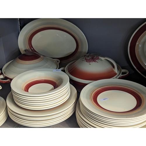 234 - A group of Susie Cooper red wedding band items to include plates, bowls, tureens, jug and others
Loc... 