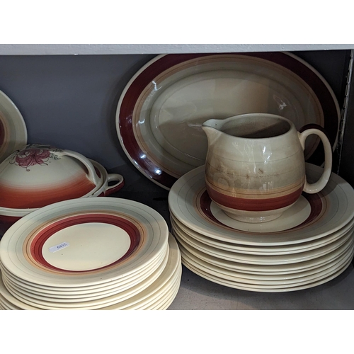 234 - A group of Susie Cooper red wedding band items to include plates, bowls, tureens, jug and others
Loc... 