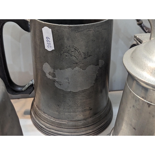 239 - Mixed items to include pewter tankards, a silver plated twin handle trophy cup, cigarette case, stam... 