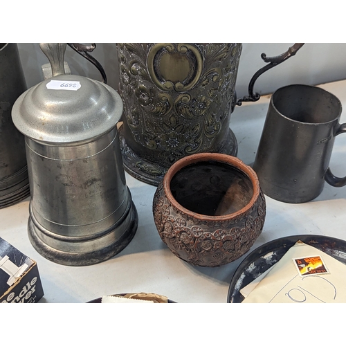 239 - Mixed items to include pewter tankards, a silver plated twin handle trophy cup, cigarette case, stam... 