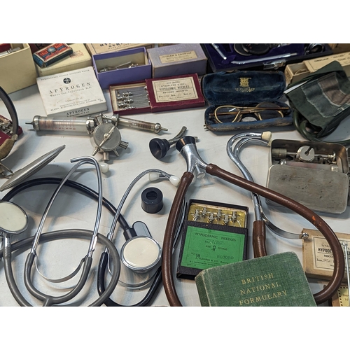 240 - A large quantity of doctors items and related to include stethoscope, otoscope, hypodermic needles, ... 