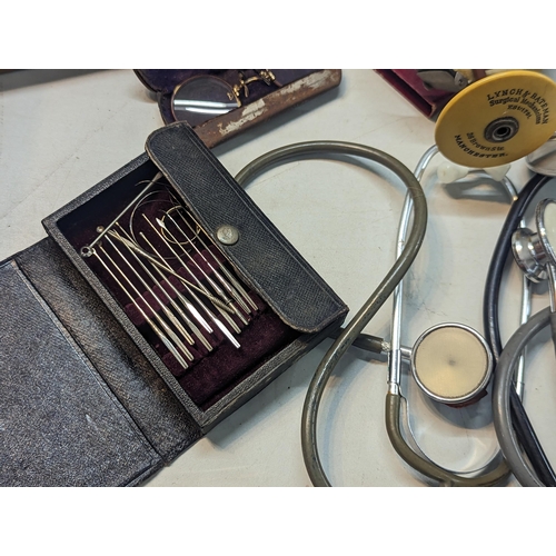 240 - A large quantity of doctors items and related to include stethoscope, otoscope, hypodermic needles, ... 