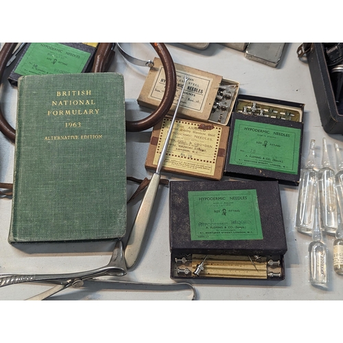 240 - A large quantity of doctors items and related to include stethoscope, otoscope, hypodermic needles, ... 