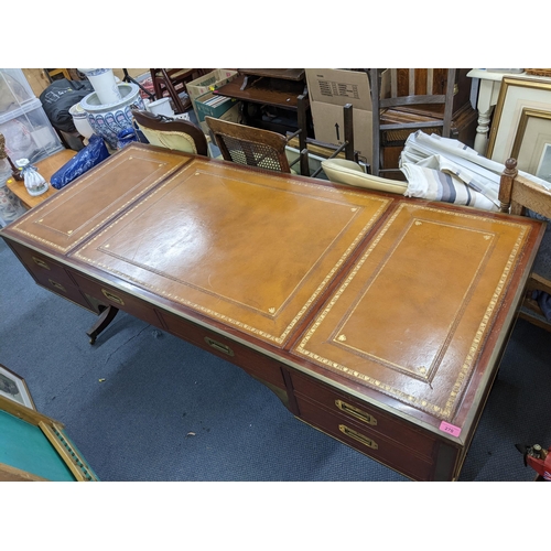 270 - A campaign style mahogany and brass mounted desk having a  leather topped scriber, sic drawers and f... 