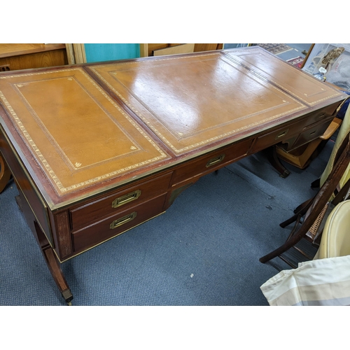 270 - A campaign style mahogany and brass mounted desk having a  leather topped scriber, sic drawers and f... 