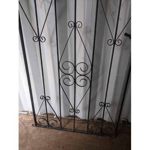 298 - A wrought metal, black painted garden gate having an arched top and scrollwork frame, 167.5h x 86w, ... 