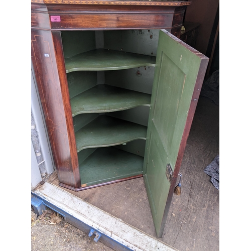 299 - A Georgian mahogany wall hanging corner cabinet, having boxwood inlaid and single cupboard door, 121... 