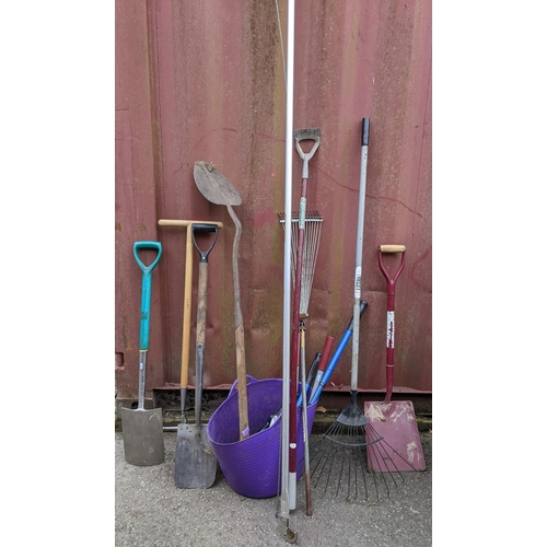 310 - A selection of gardening tools to include a rake, a shovel, trimmers and other items Location:CON