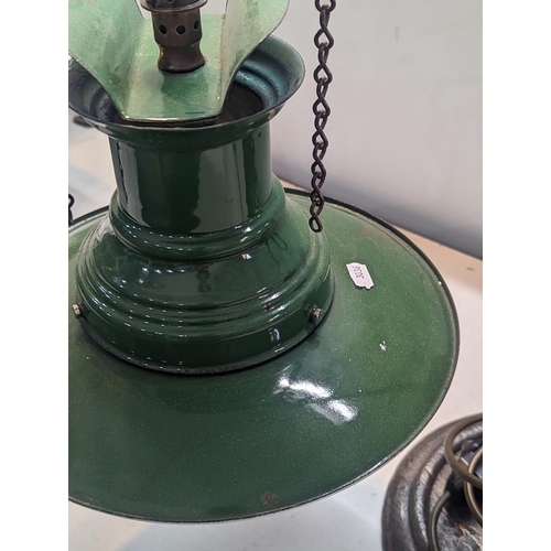 322 - An Industrial style desk lamp having a vintage 1940s green enamel railway lamp shade on a later bras... 