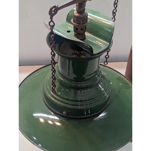 322 - An Industrial style desk lamp having a vintage 1940s green enamel railway lamp shade on a later bras... 