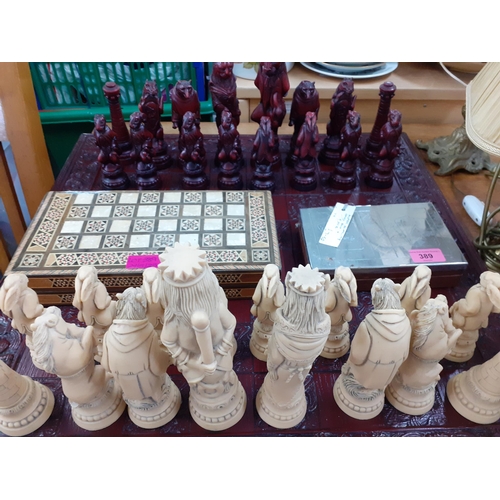 389 - An Alice in Wonderland style composition chess set, together with a playing card storage box, a smal... 