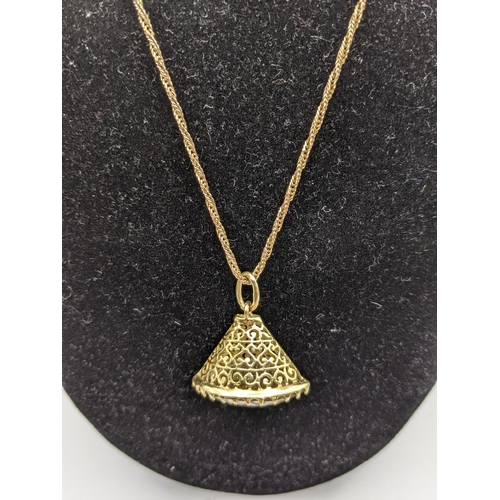 83 - A 9ct gold chain together with a yellow metal pendant inset with a clear stone, 10.2 grams Location:... 