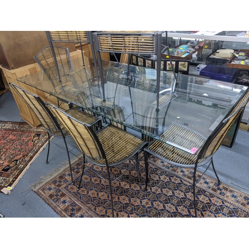 351 - A wrought metal and bamboo framed dining table having a glass top, 76h x 190w, together with six mat... 