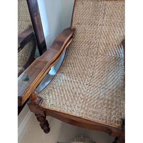 283 - A teak framed plantation chair with a cane back and seat, foldout arms and turned legs
Location: A2B