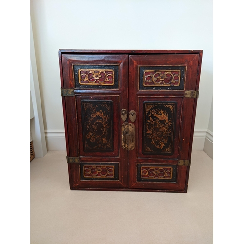 288 - A pair of Chinese red and gold lacquered cabinets, each with a pair of panelled doors, 57cm high,  5... 